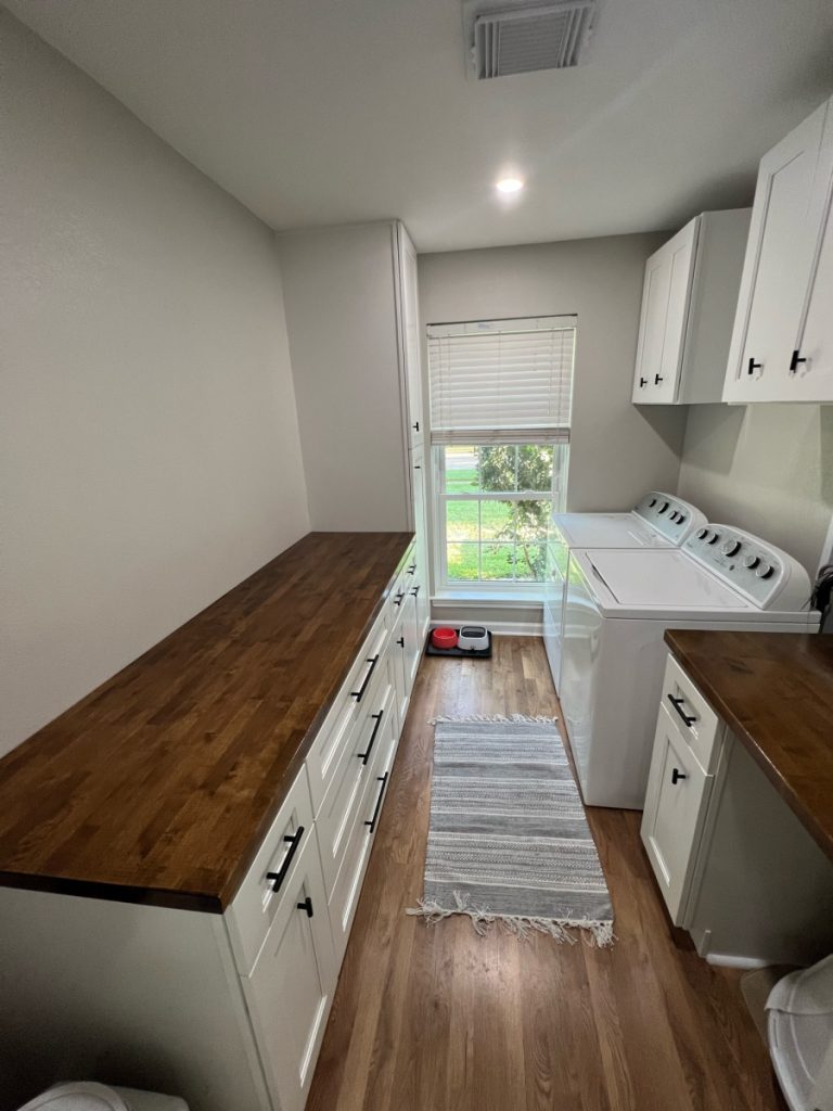 Laundry room with butcher block counter and new cabinets in a Spring Branch remodel