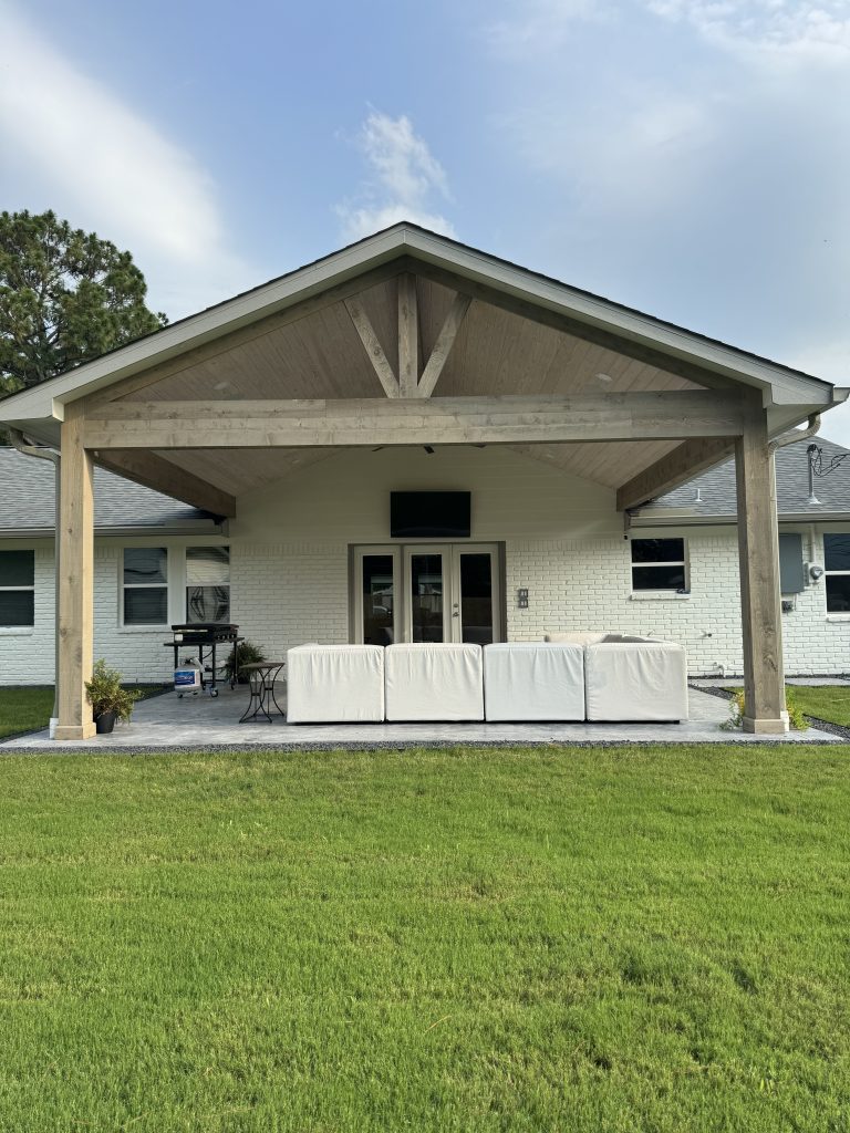 Cedar-beam covered patio with vaulted ceiling at a Meyerland home, Houston