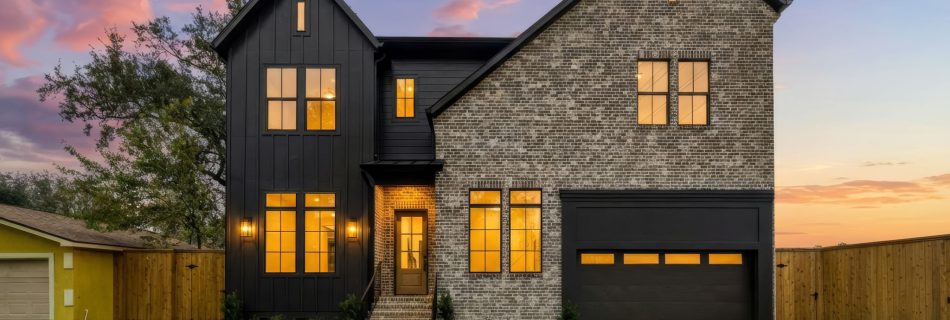 Front of a new two-story Bellaire custom home with stone and black board-and-batten siding