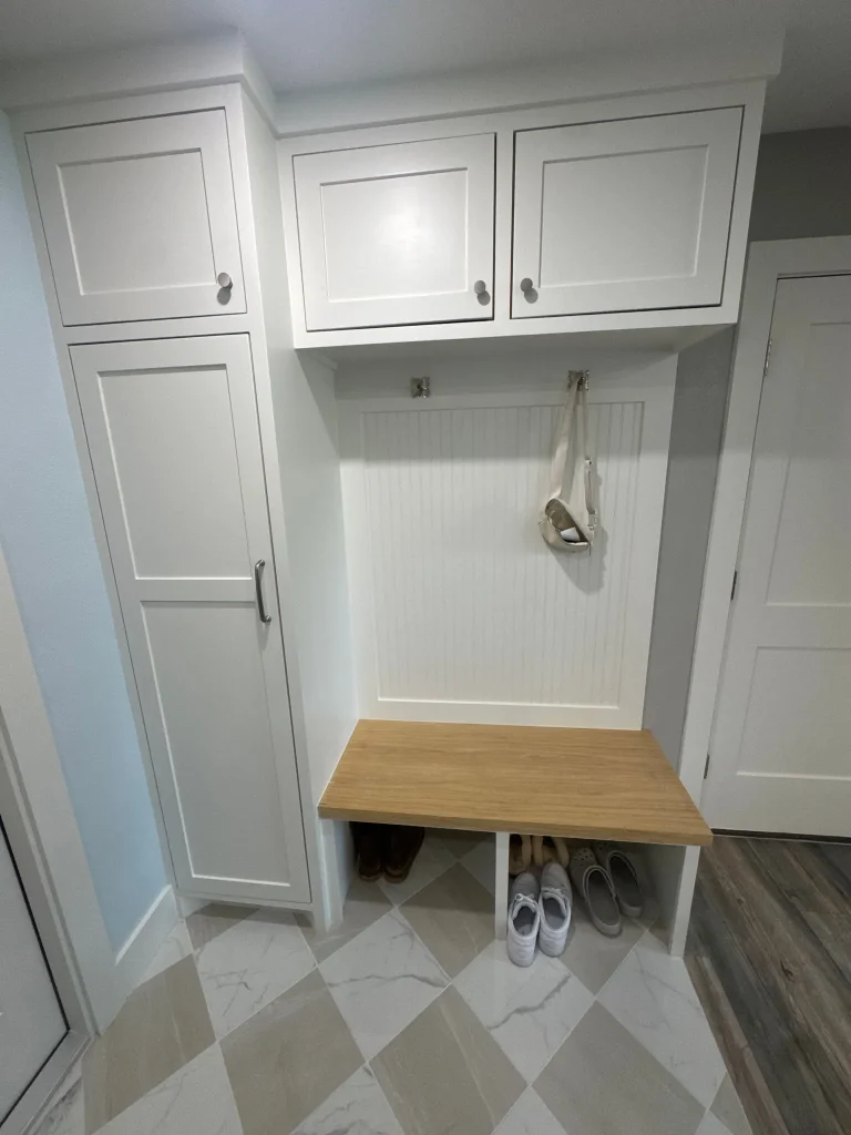 Custom mudroom built-in with beadboard paneling and hooks, built by Select Build in a Houston home
