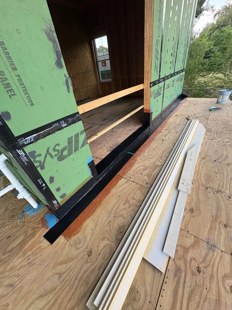 Exterior door opening sealed with liquid flashing and membrane before the door is installed