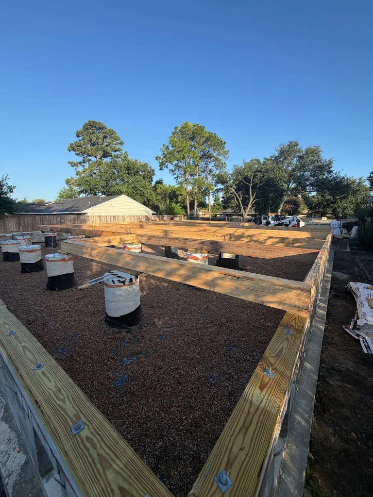 Crawlspace piers and floor framing that lift the Westbury new build above grade
